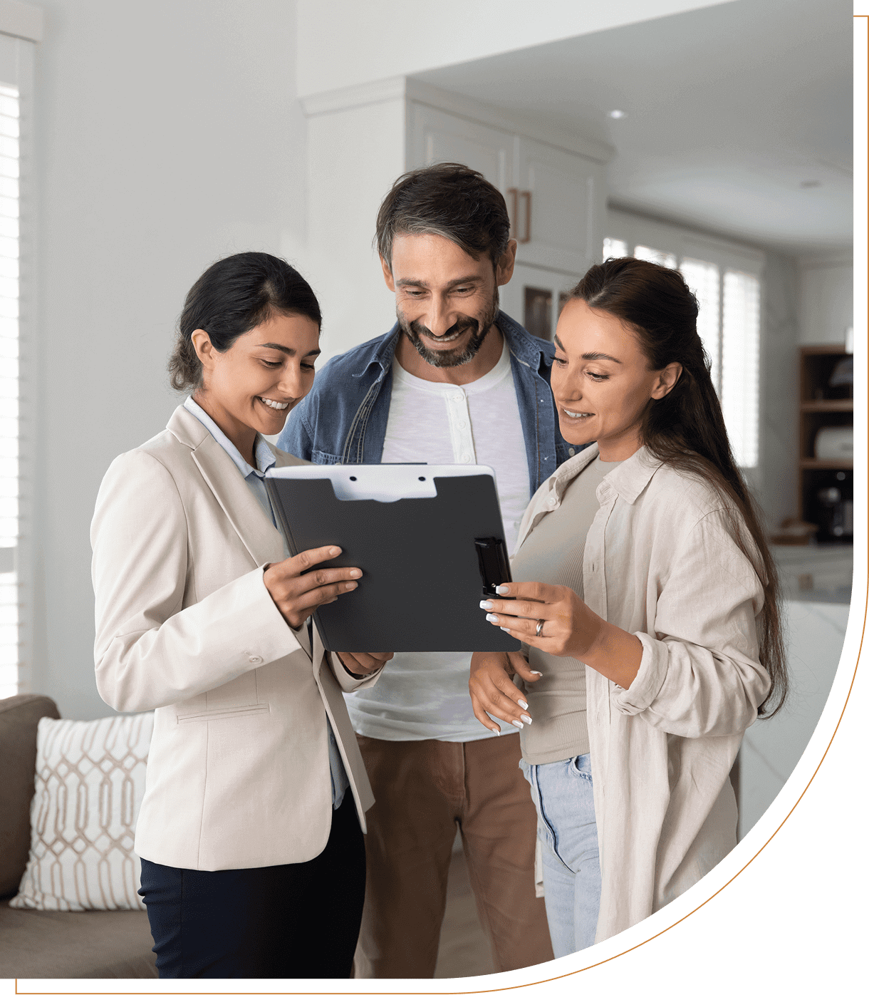 People reviewing documents in a modern living room.