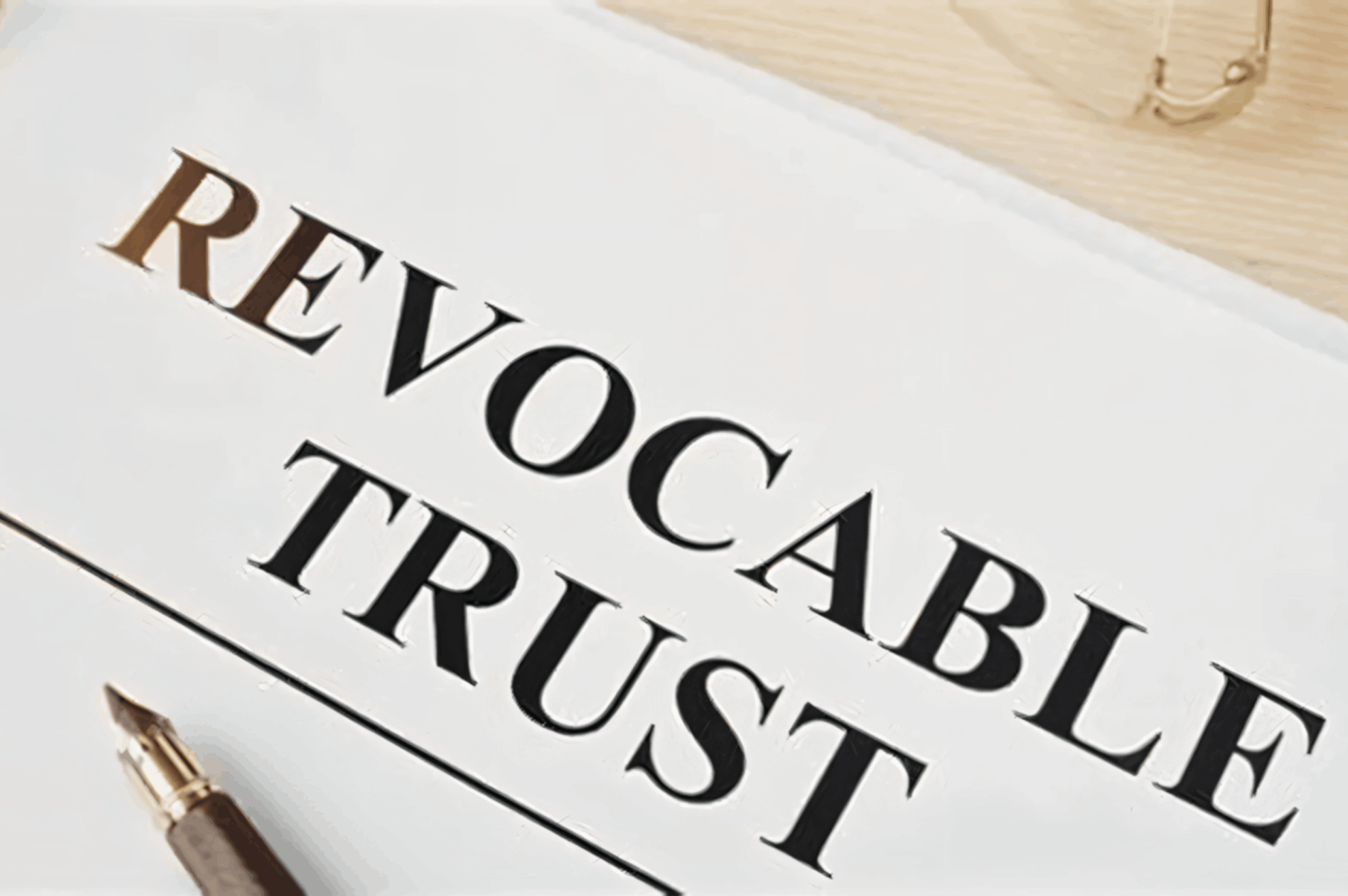 Document titled "Revocable Trust" with pen.