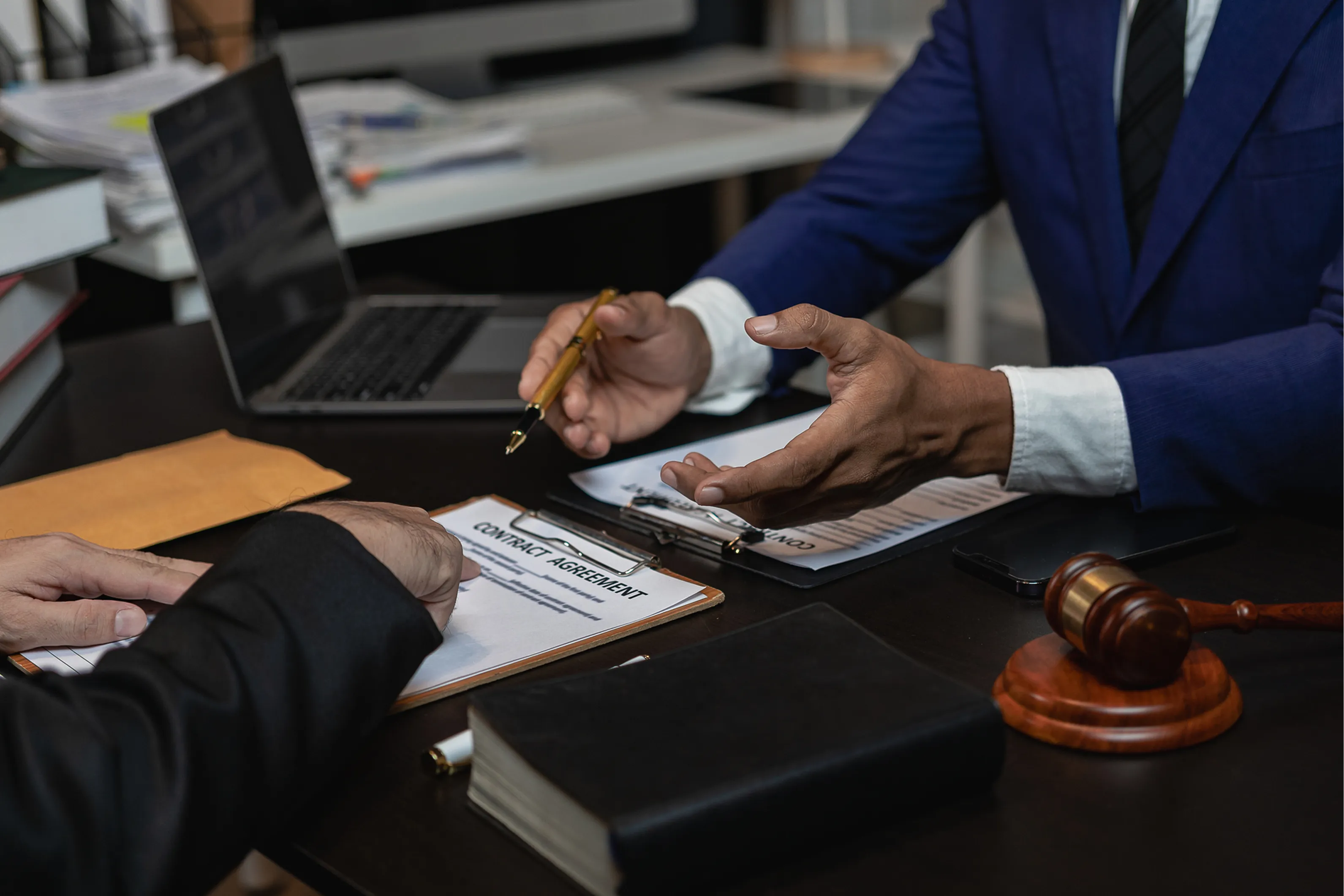 Lawyers discussing documents in an office setting.