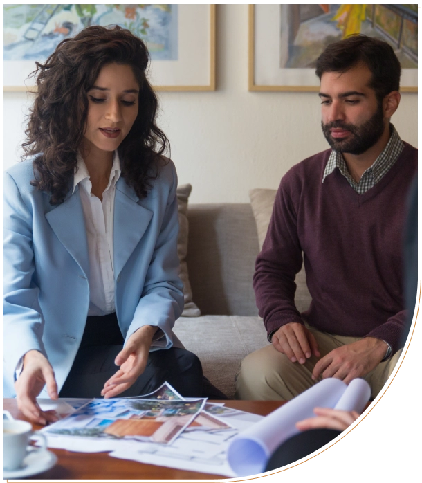 A woman and a man reviewing documents together on a couch.