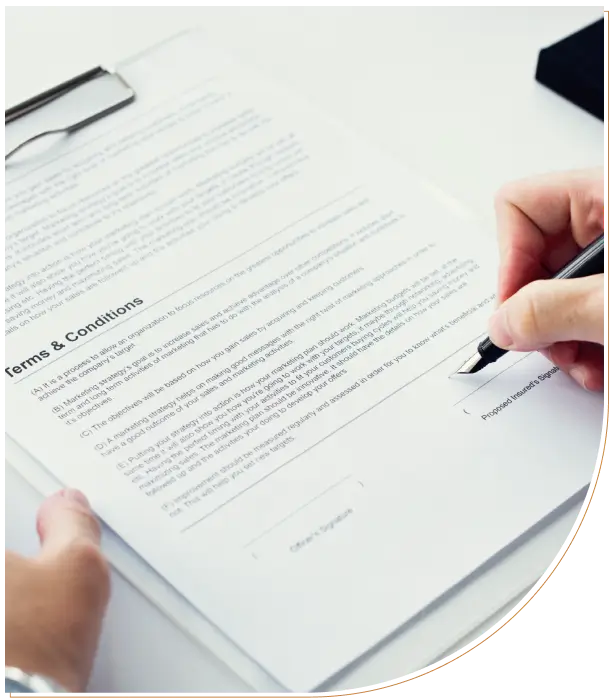 Person signing a formal document with a pen.