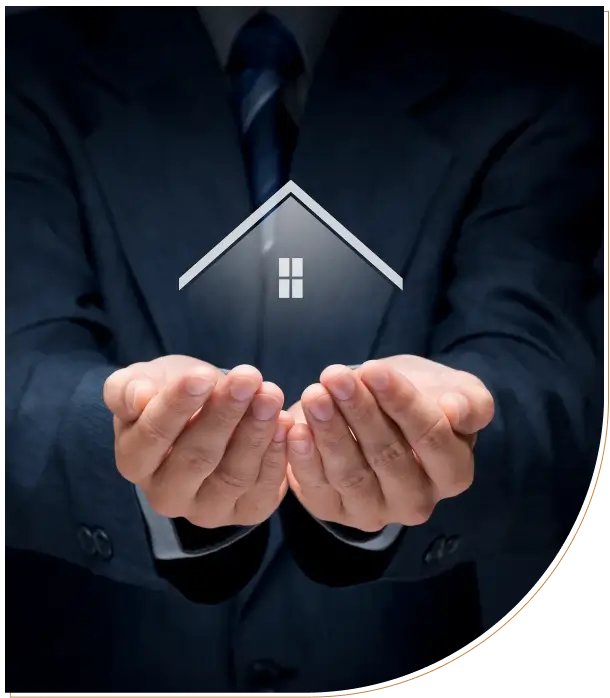 Businessman holding a glowing house icon symbolizing real estate.