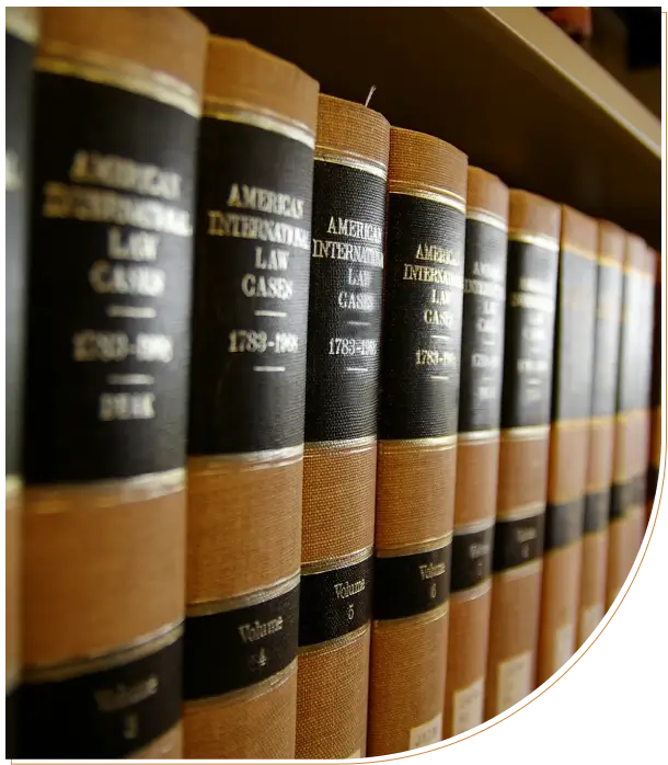 A row of legal books with black and gold labels on a shelf.